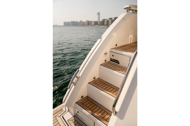 My Serenity Yacht Photos Pics Staircase on 2018 Sunseeker Manhattan 66 yacht with ocean and city skyline view.
