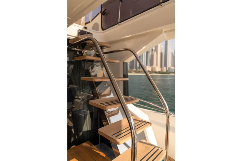 My Serenity Yacht Photos Pics Staircase on 2018 Sunseeker Manhattan 66 yacht with city skyline view.