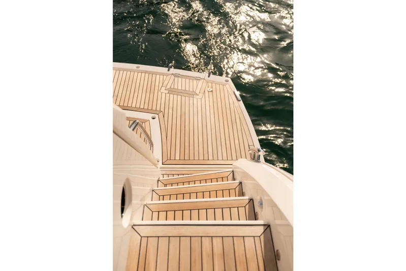 My Serenity Yacht Photos Pics Staircase on 2018 Sunseeker Manhattan 66 yacht, leading to sunlit water.