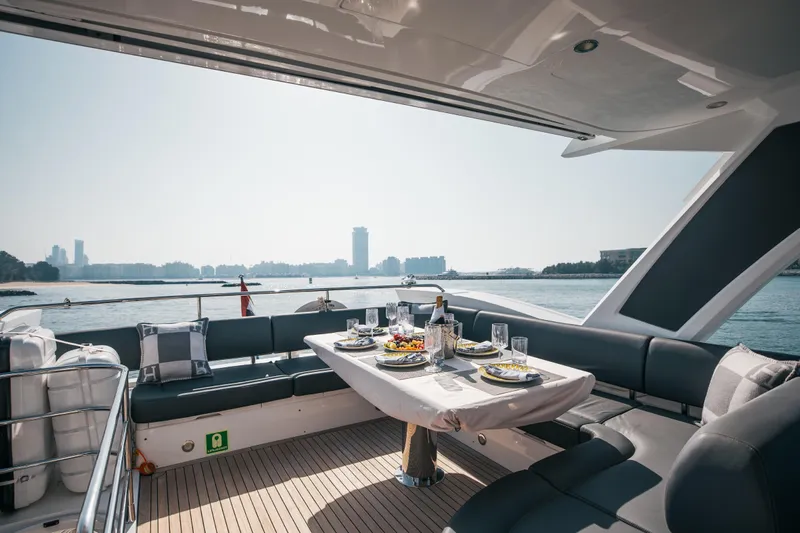 My Serenity Yacht Photos Pics Luxurious 2018 Sunseeker Manhattan 66 yacht with elegant outdoor dining setup.