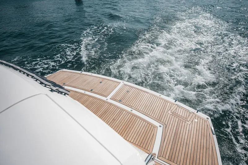 My Serenity Yacht Photos Pics 2018 Sunseeker Manhattan 66 yacht cruising, showcasing elegant teak deck and ocean waves.