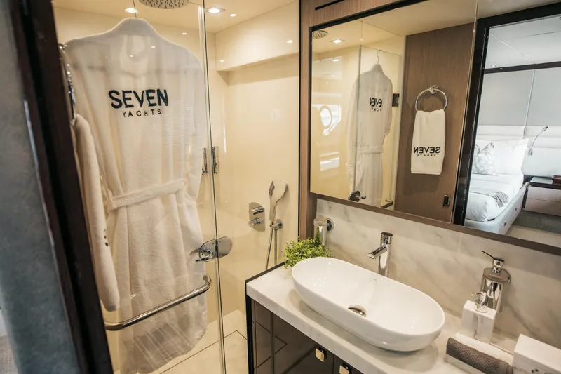 My Serenity Yacht Photos Pics Luxurious bathroom on 2018 Sunseeker Manhattan 66 yacht with elegant fixtures and robe.