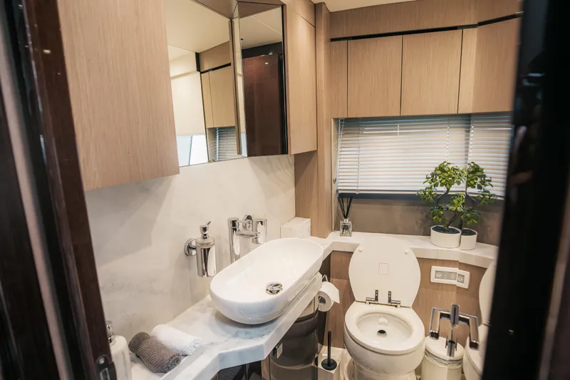 My Serenity Yacht Photos Pics Luxurious bathroom in 2018 Sunseeker Manhattan 66 yacht with modern fixtures and elegant design.