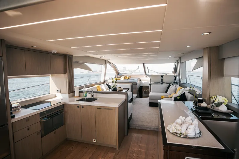My Serenity Yacht Photos Pics Luxurious interior of 2018 Sunseeker Manhattan 66 yacht with modern kitchen and seating area.
