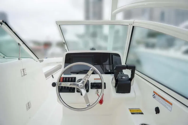 51980 230dc Nap Yacht Photos Pics Manufacturer Provided Image: 2025 World Cat 230 DC boat helm with steering wheel and controls.