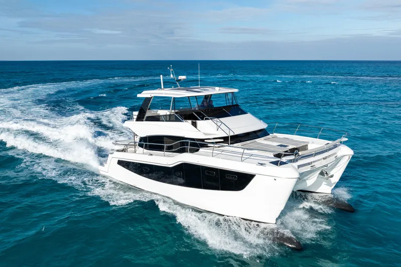  Yacht Photos Pics 2026 Aquila 50 Yacht cruising on open blue ocean waters.