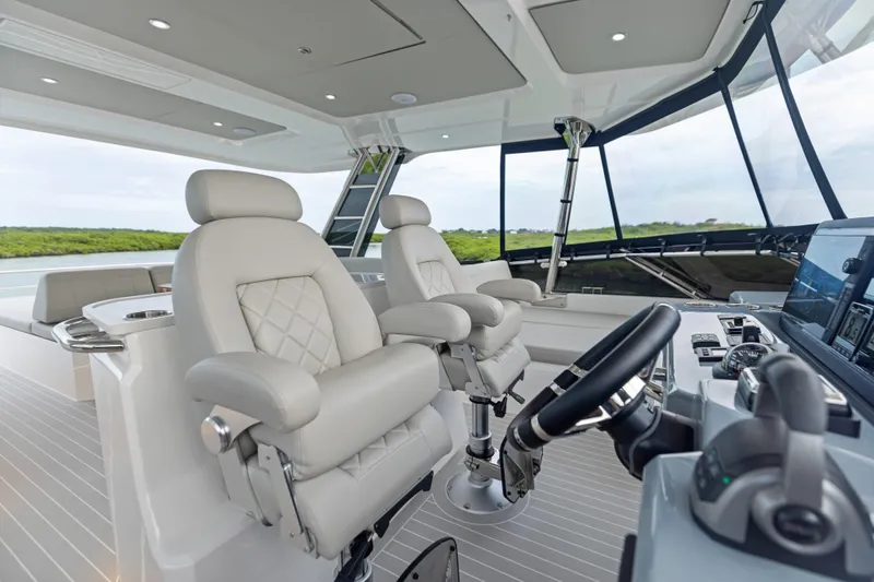  Yacht Photos Pics Luxurious helm of 2026 Aquila 50 Yacht with plush seating and advanced controls.