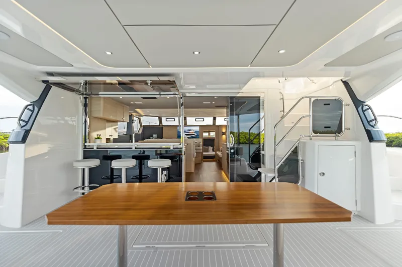  Yacht Photos Pics Luxurious interior of 2026 Aquila 50 Yacht featuring modern bar and seating area.