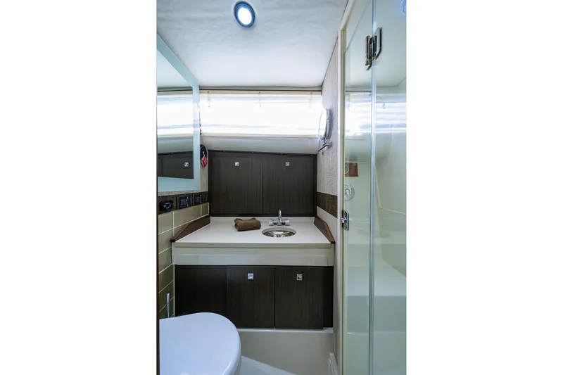 Field & Sea Yacht Photos Pics 1965 Bertram 38 Sport Fisherman bathroom with modern fixtures and sleek design.