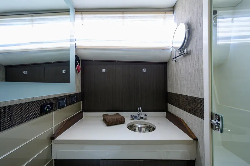 Field & Sea Yacht Photos Pics 1965 Bertram 38 Sport Fisherman bathroom with modern sink and mirror.