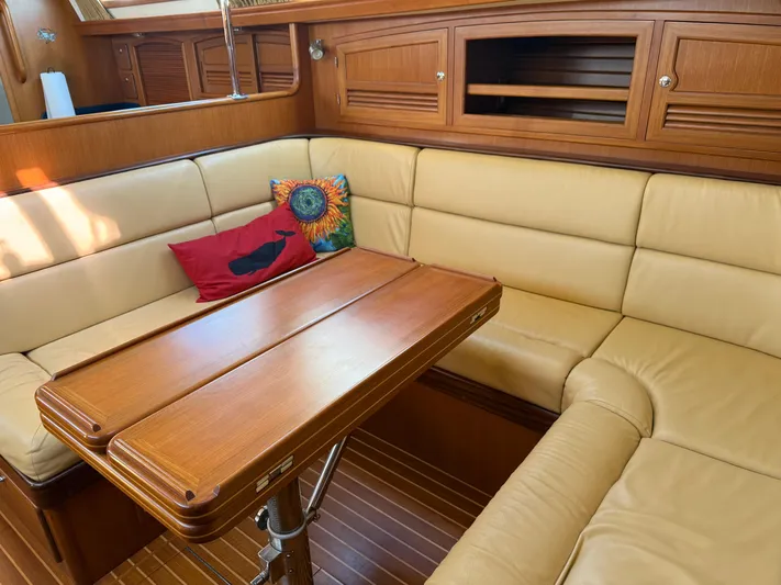 Aevitas Yacht Photos Pics Luxurious interior of 2011 Outbound 46 yacht with wooden table and beige seating.