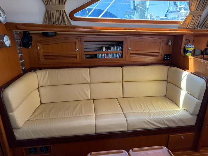 Aevitas Yacht Photos Pics Luxurious interior of 2011 Outbound 46 yacht with cream leather sofa and wooden cabinetry.