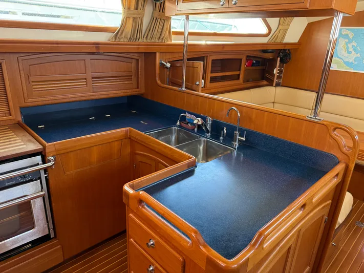 Aevitas Yacht Photos Pics Luxurious 2011 Outbound 46 yacht kitchen with wood cabinetry and modern appliances.