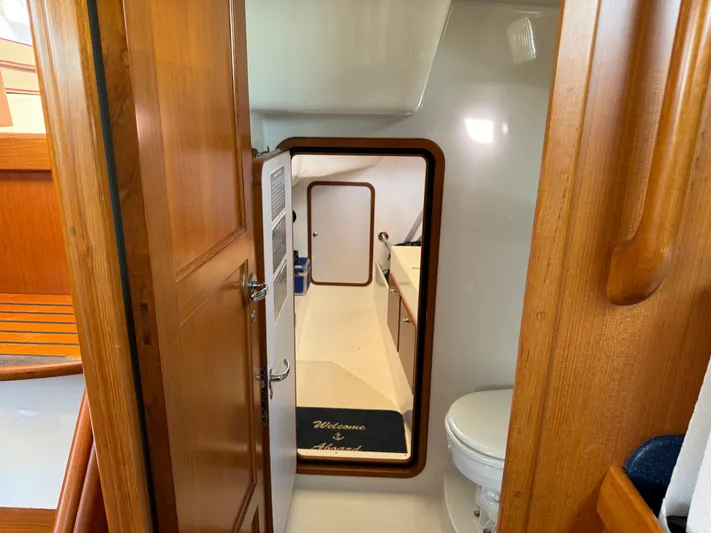 Aevitas Yacht Photos Pics Interior of 2011 Outbound 46 yacht showing bathroom and wooden cabinetry.