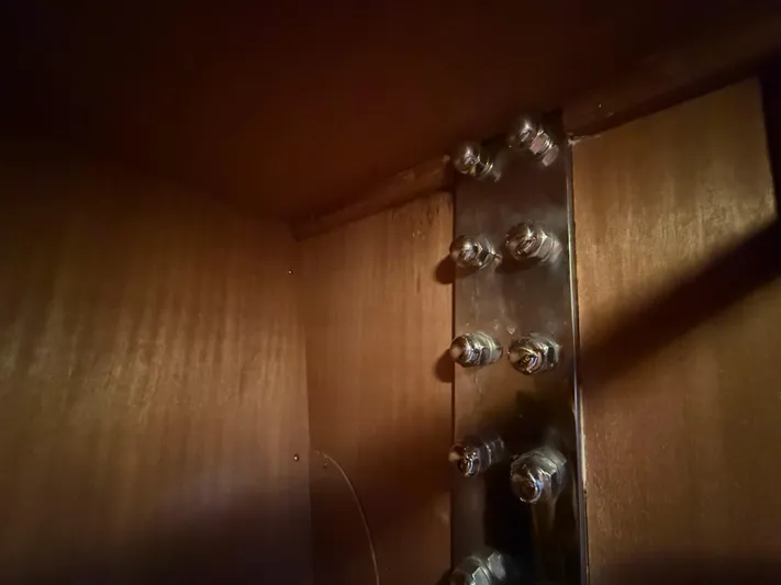 Aevitas Yacht Photos Pics Interior view of 2011 Outbound 46 sailboat, showcasing metal bolts on wooden panel.