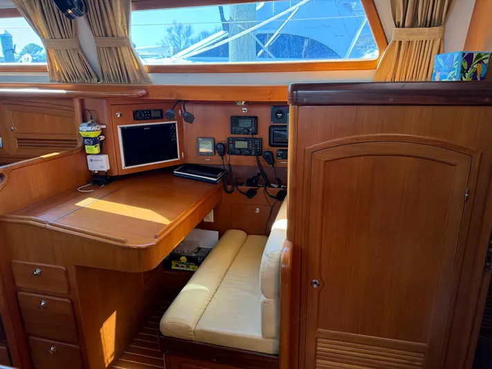 Aevitas Yacht Photos Pics Luxurious 2011 Outbound 46 yacht interior with navigation station and wooden cabinetry.