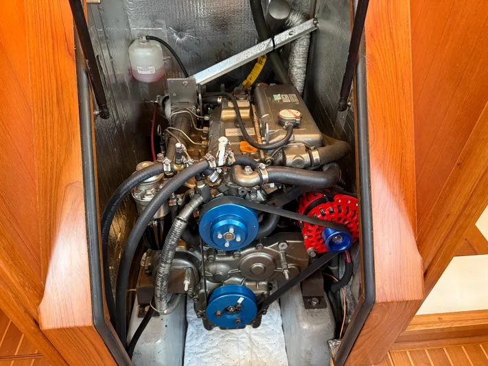 Aevitas Yacht Photos Pics Engine compartment of a 2011 Outbound 46 sailboat, showcasing mechanical components and wiring.