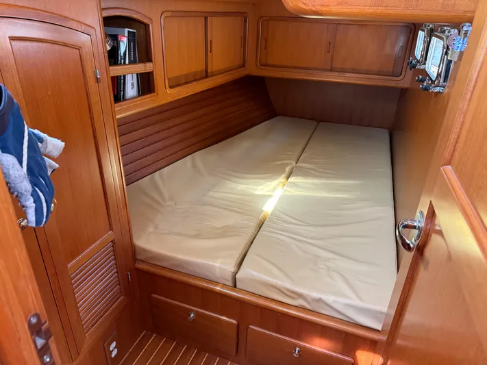 Aevitas Yacht Photos Pics Cozy cabin interior of 2011 Outbound 46 yacht with wooden finish and comfortable bedding.