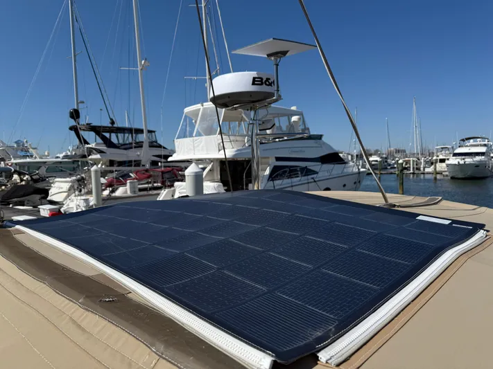 Aevitas Yacht Photos Pics Solar panel on 2011 Outbound 46 yacht in marina, clear blue sky background.