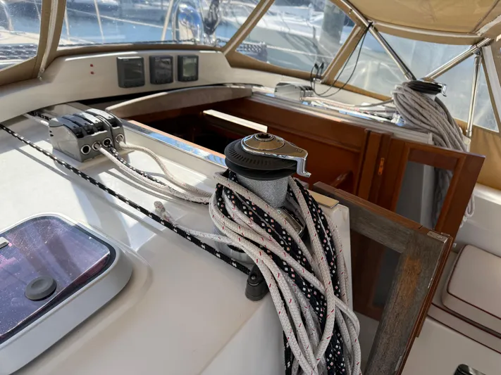 Aevitas Yacht Photos Pics 2011 Outbound 46 sailboat cockpit with ropes and winch, showcasing navigation equipment.
