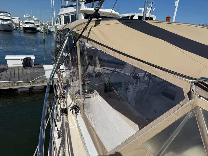 Aevitas Yacht Photos Pics Sailboat docked at marina, featuring beige canopy, Outbound 46 model, 2011.