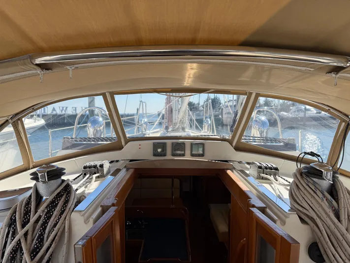 Aevitas Yacht Photos Pics Interior view of 2011 Outbound 46 sailboat cockpit with ropes and navigation instruments.