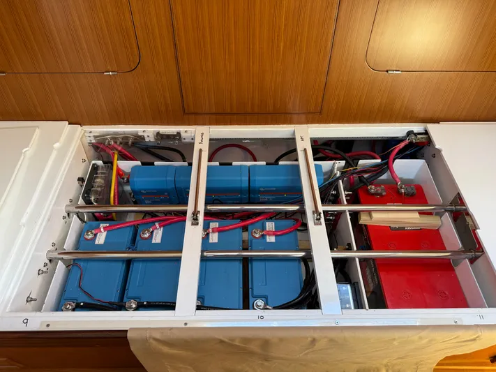 Aevitas Yacht Photos Pics Battery compartment of a 2011 Outbound 46 yacht, featuring organized wiring and secure battery placement.
