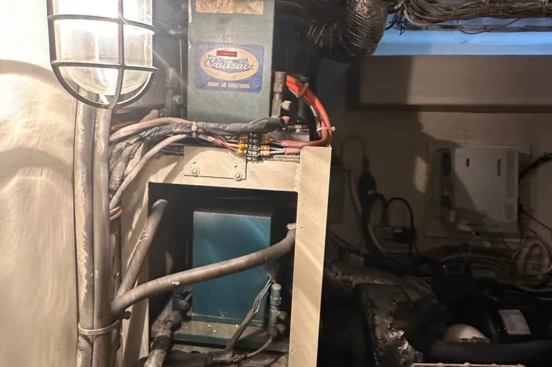 Apple 1 Yacht Photos Pics Engine room of 1974 Hatteras 58 Yachtfish, showcasing wiring and machinery components.