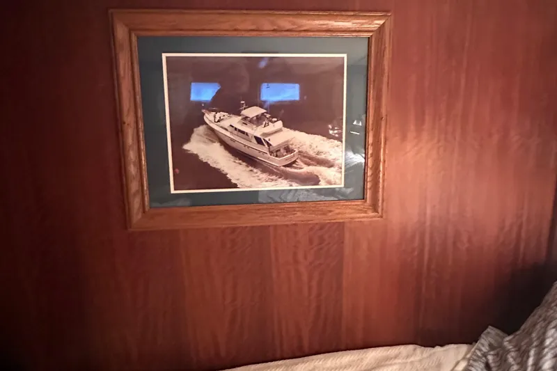 Apple 1 Yacht Photos Pics Framed photo of a 1974 Hatteras 58 Yachtfish on a wooden wall.
