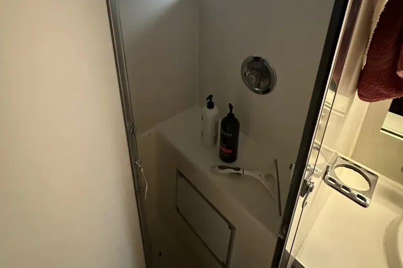 Apple 1 Yacht Photos Pics Shower area in 1974 Hatteras 58 Yachtfish with toiletries and modern fixtures.