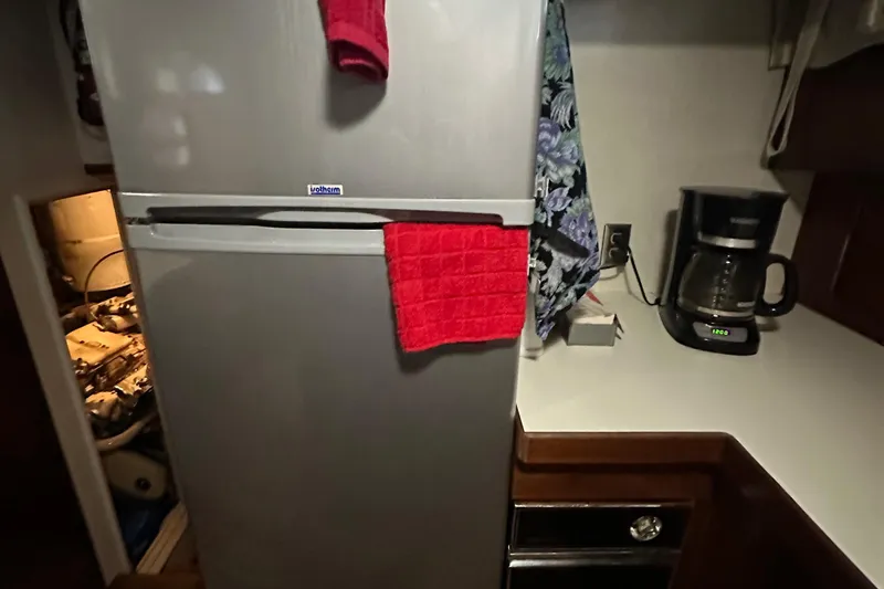 Apple 1 Yacht Photos Pics 1974 Hatteras 58 Yachtfish kitchen with fridge, coffee maker, and red towel.