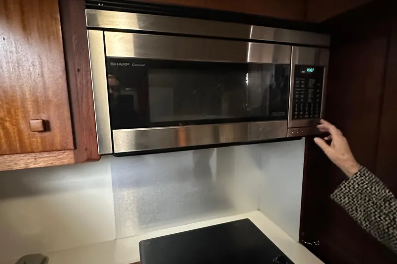 Apple 1 Yacht Photos Pics Microwave in 1974 Hatteras 58 Yachtfish kitchen, with wooden cabinets and modern design.