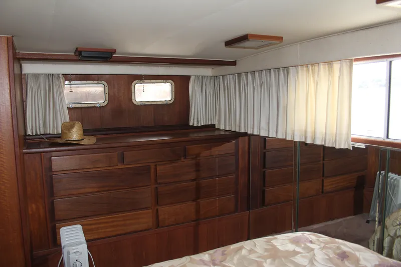 Apple 1 Yacht Photos Pics Interior of 1974 Hatteras 58 Yachtfish with wooden cabinetry and curtains.