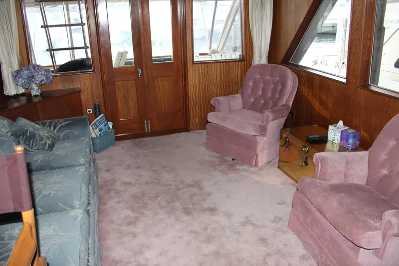 Apple 1 Yacht Photos Pics Interior of 1974 Hatteras 58 Yachtfish with plush seating and wood paneling.