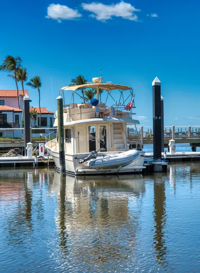 Oasis Yacht Photos Pics 2006 Mainship 34 Trawler docked in sunny marina.