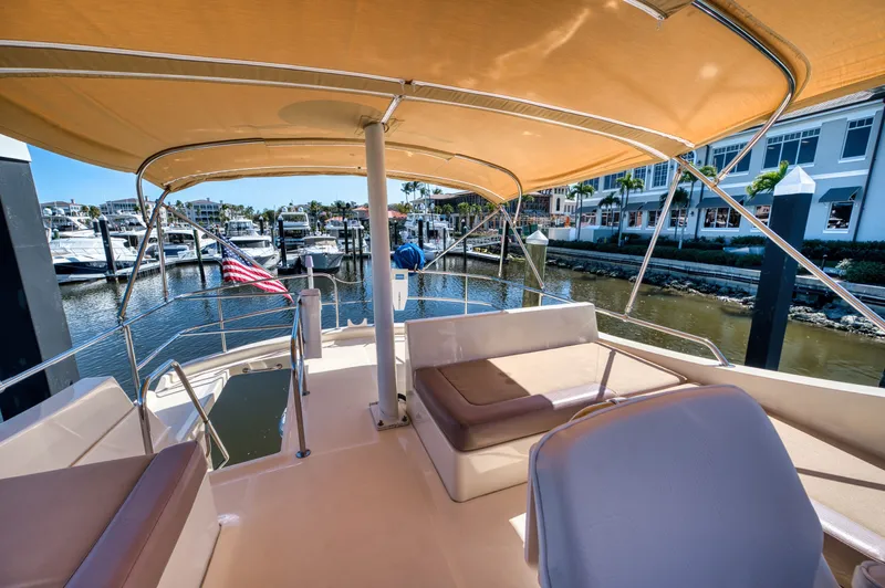 Oasis Yacht Photos Pics 2006 Mainship 34 Trawler with sunshade at marina.