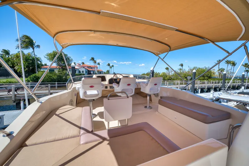 Oasis Yacht Photos Pics 2006 Mainship 34 Trawler with covered helm and seating area.