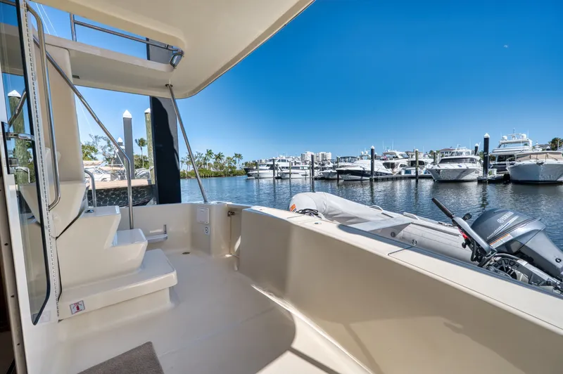 Oasis Yacht Photos Pics 2006 Mainship 34 Trawler docked with dinghy and motor.