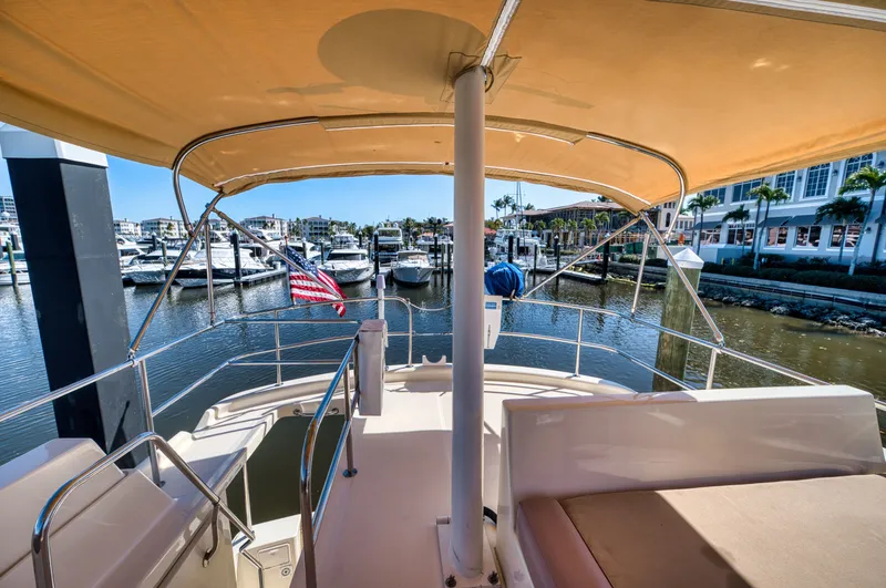 Oasis Yacht Photos Pics 2006 Mainship 34 Trawler docked with sunshade.
