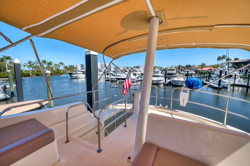 Oasis Yacht Photos Pics 2006 Mainship 34 Trawler in sunny marina setting.