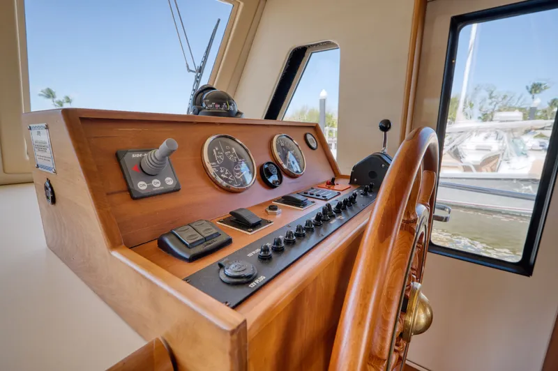 Oasis Yacht Photos Pics Helm of a 2006 Mainship 34 Trawler with wooden wheel.
