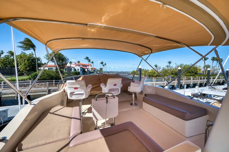 Oasis Yacht Photos Pics Interior view of 2006 Mainship 34 Trawler with seating area.