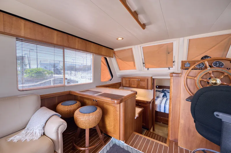 Oasis Yacht Photos Pics Interior of a 2006 Mainship 34 Trawler with wooden furnishings.