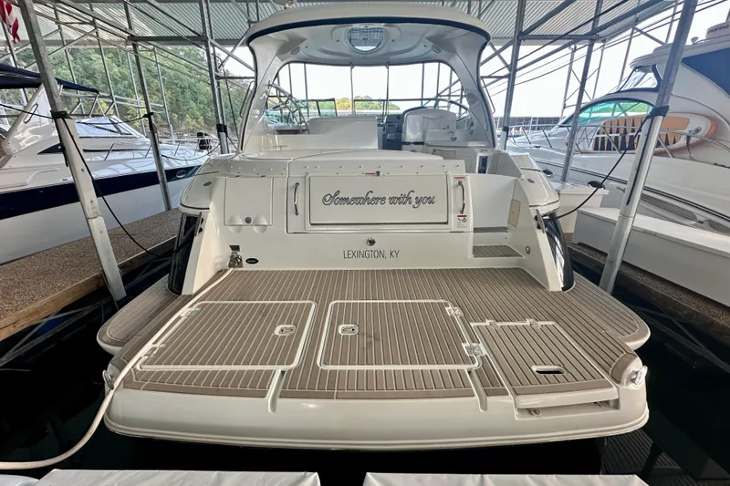 Somewhere With You Yacht Photos Pics 2009 Cruisers Yachts 460 Express docked, rear view with spacious deck and canopy.