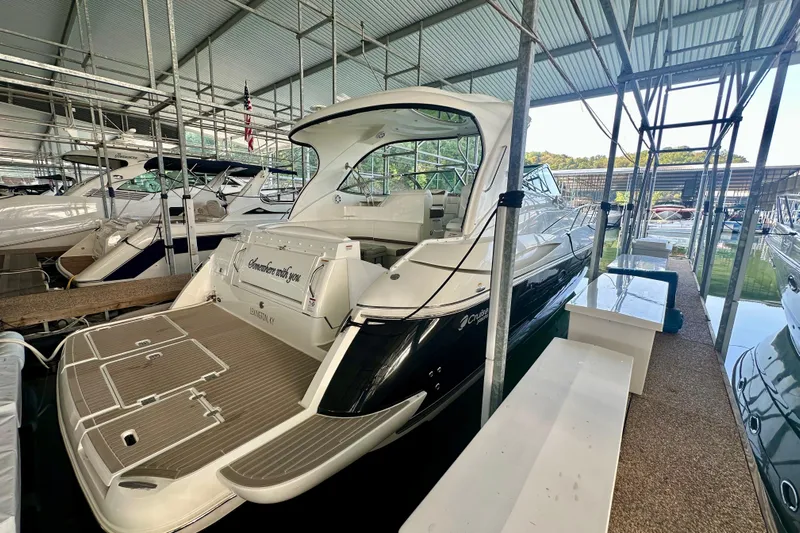 Somewhere With You Yacht Photos Pics 2009 Cruisers Yachts 460 Express docked in a marina under a metal roof.