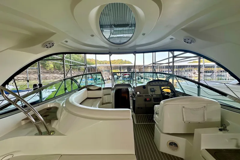 Somewhere With You Yacht Photos Pics Interior view of 2009 Cruisers Yachts 460 Express, featuring helm and seating area.