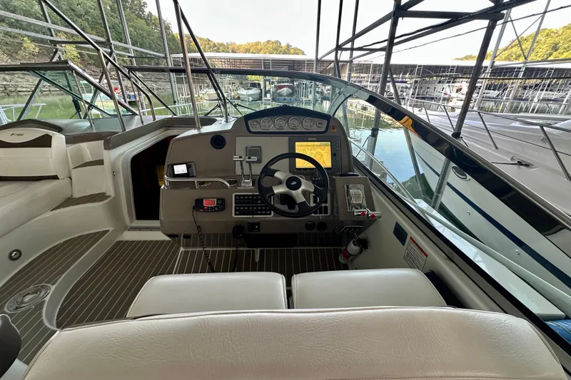 Somewhere With You Yacht Photos Pics 2009 Cruisers Yachts 460 Express helm with navigation equipment and marina view.
