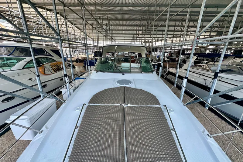 Somewhere With You Yacht Photos Pics 2009 Cruisers Yachts 460 Express in marina, surrounded by other boats.