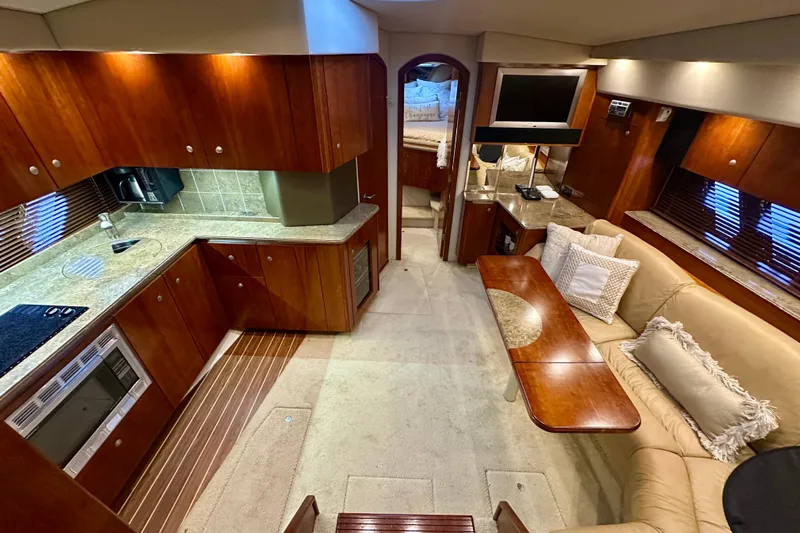 Somewhere With You Yacht Photos Pics Luxurious interior of 2009 Cruisers Yachts 460 Express with elegant wood finishes and modern amenities.