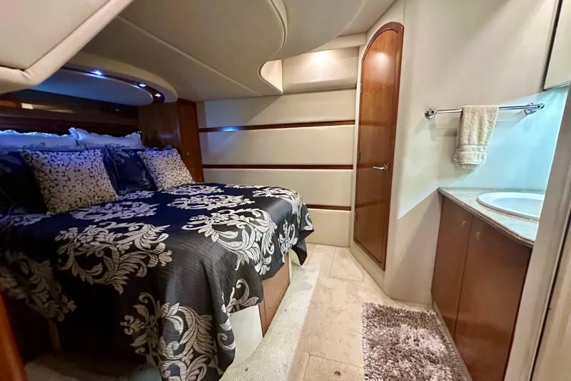 Somewhere With You Yacht Photos Pics Luxurious 2009 Cruisers Yachts 460 Express cabin with elegant bedding and ensuite bathroom.